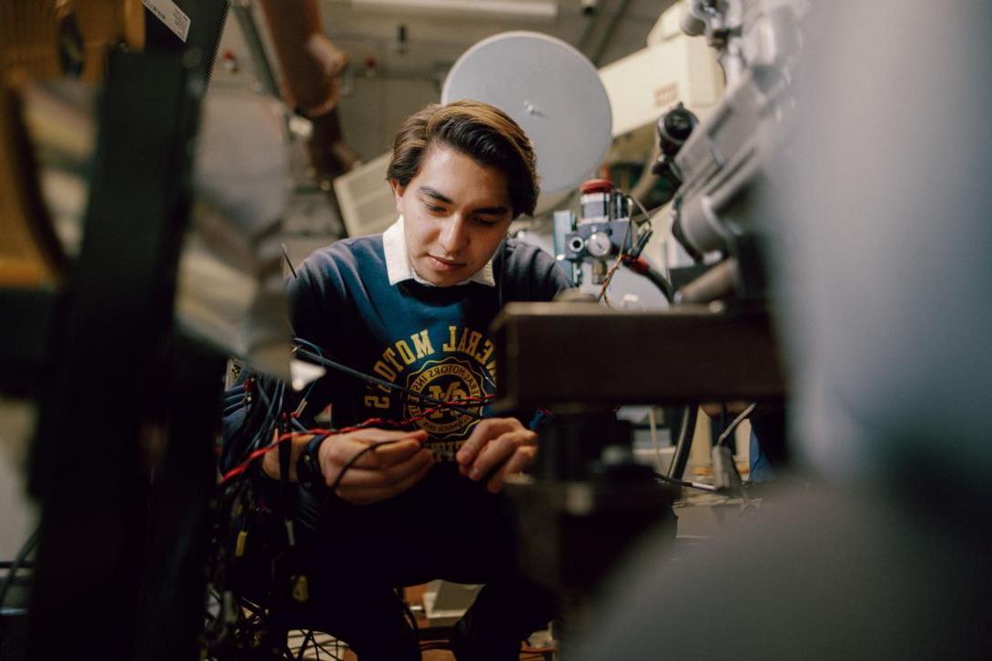 A Kettering mechanical engineering student connects black and red wires